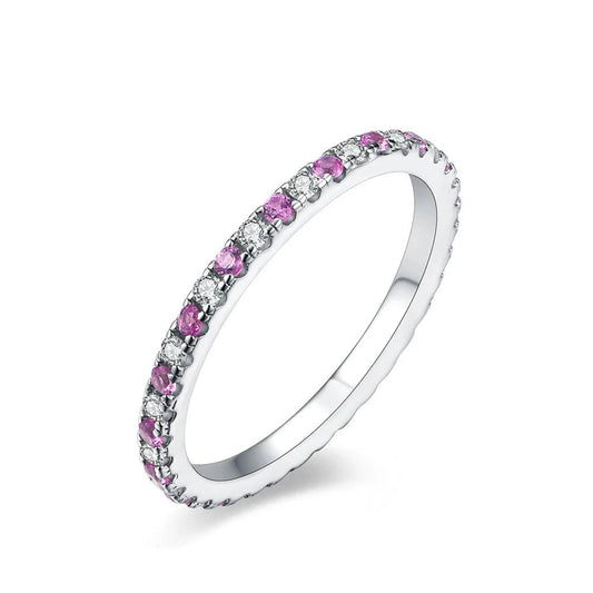 Moissanite ring with purple and clear stones in white gold-plated silver.