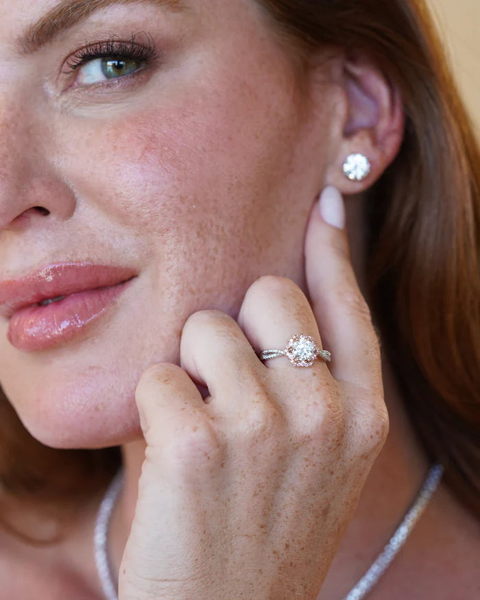 Close-up of a woman wearing an Éden Moissanite Ring and matching earrings, showcasing elegant jewelry design.